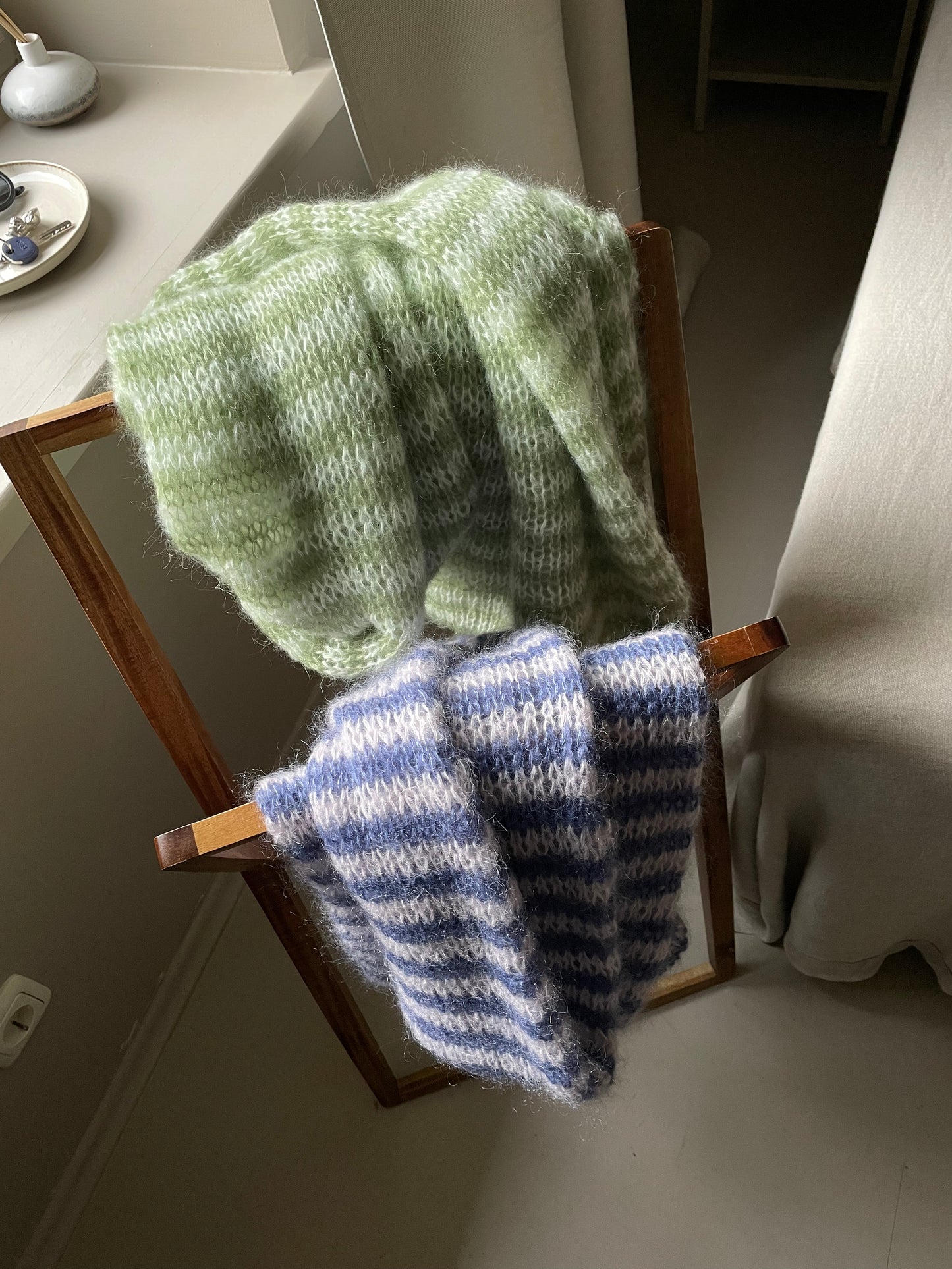 two scarves: green striped and blue white striped with fine stripes